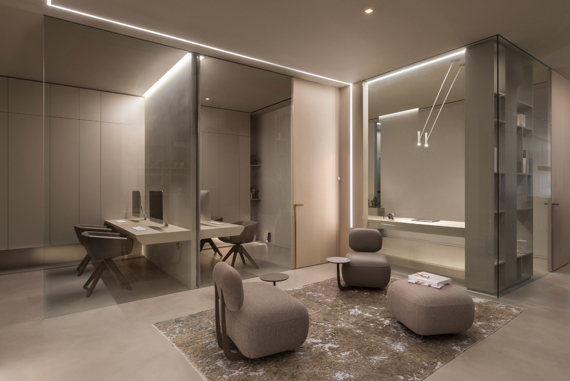 Elegant modern office interior with linear LED lighting along ceiling and walls, glass partitions, curved beige furniture, floating desk, and soft ambient glow